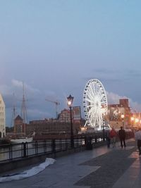 Ferris wheel in city against sky