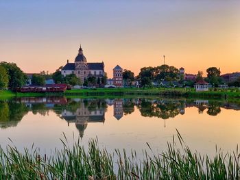 Reflection of building in lake at sunset