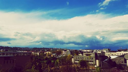 Buildings against cloudy sky