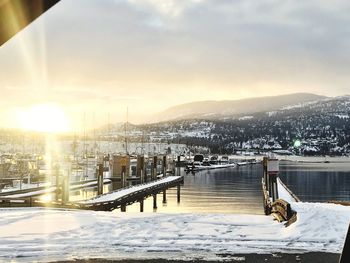 Beautiful sunrise over winter dock in the mountains.