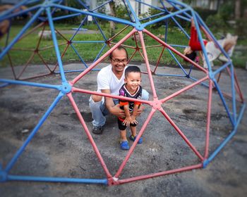 Man and boy playing at playground