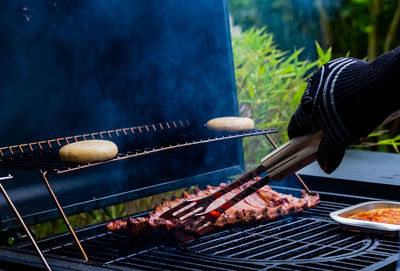 Handling meat on grill 