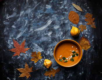 High angle view of autumn leaves on table