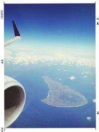 Cropped image of airplane flying over sea