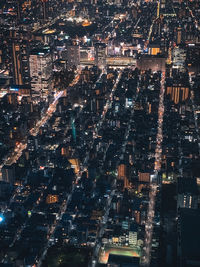 High angle view of city lit up at night