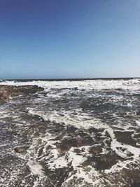 Scenic view of sea against clear blue sky