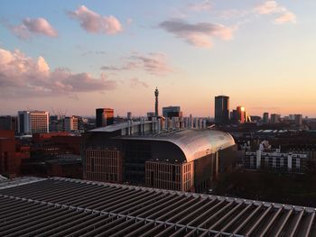 View of cityscape against cloudy sky