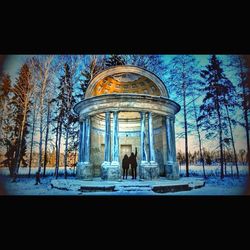 People in snow against sky during winter