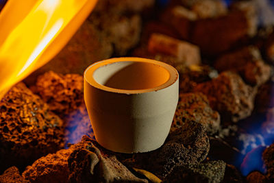 High angle view of coffee cup on rock