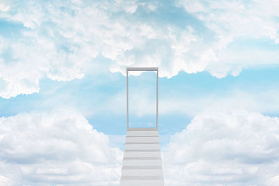 Digital composite image of staircase against sky