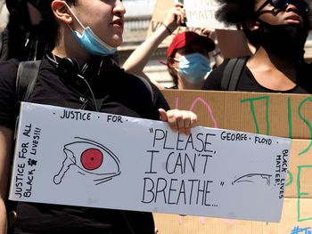 Close-up of people with text on paper