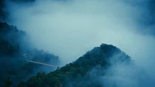 Scenic view of mountains against cloudy sky