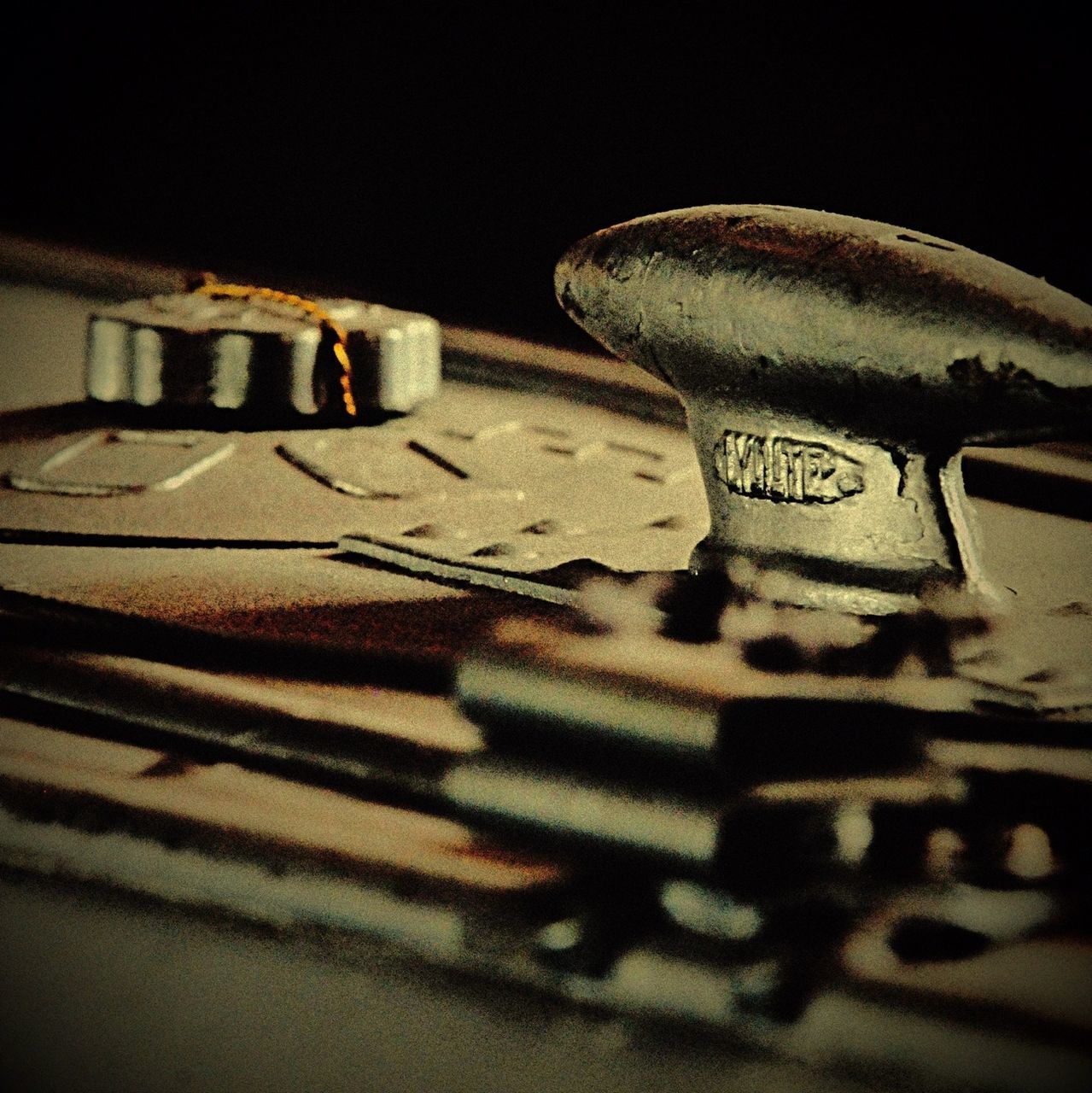 indoors, close-up, selective focus, still life, no people, text, table, surface level, shadow, street, wall - building feature, focus on foreground, sunlight, night, old, flooring, art and craft, western script, high angle view