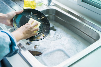 Cropped hand washing car