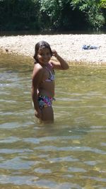 Portrait of shirtless girl in water