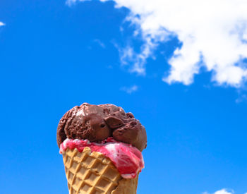 Close-up of ice cream against blue sky