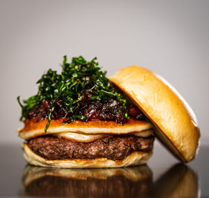 Close-up of burger against white background