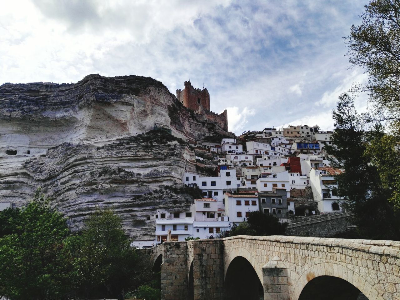 architecture, built structure, building exterior, sky, tree, cloud - sky, cloud, arch, cloudy, day, history, travel destinations, outdoors, city, mountain, no people, famous place, low angle view, castle, residential structure