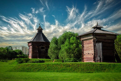 Built structure on field against sky
