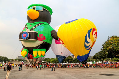 Multi colored hot air balloons flying against sky