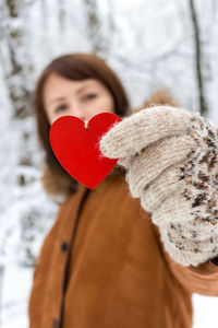 Portrait of woman holding heart shape. happy valentines day. love concept.