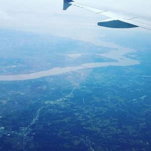 Aerial view of airplane wing over landscape