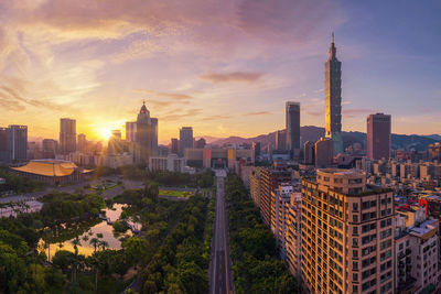 Panoramic view of buildings in city against sky during sunset