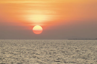 Scenic view of sea against orange sky