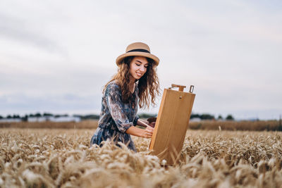 Young woman wearing hat on field