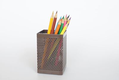 Close-up of multi colored pencils against white background