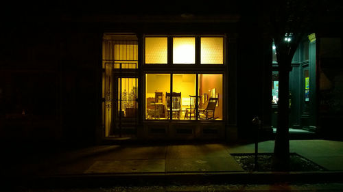 Illuminated window in city at night