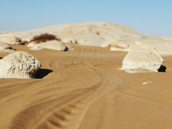 Sand dune in desert against clear sky