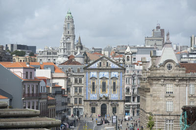 Buildings against cloudy sky