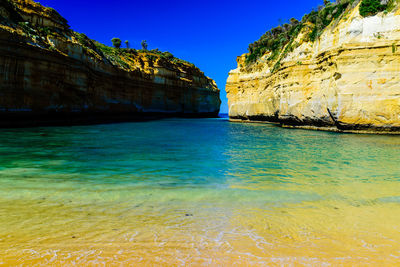 Scenic view of sea against clear blue sky