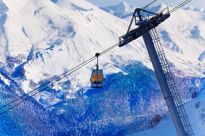 Overhead cable car over snowcapped mountains