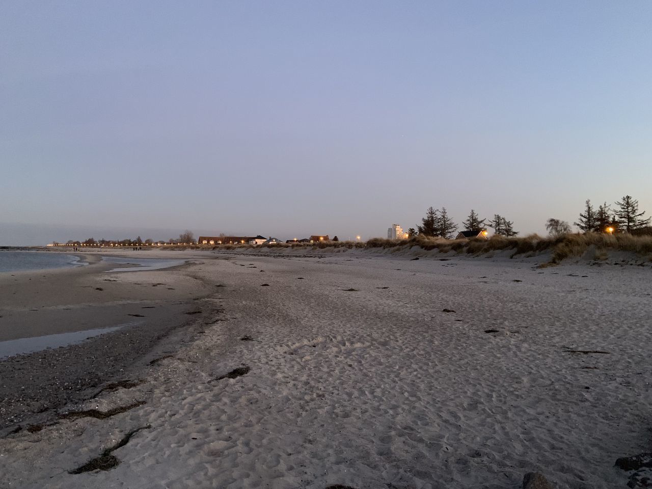 SURFACE LEVEL OF BEACH AGAINST SKY