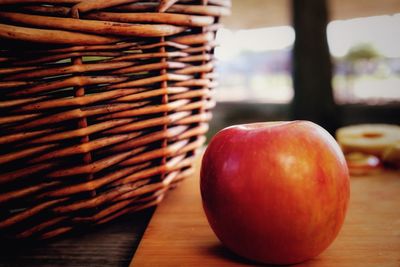 Close-up of apples in basket on table