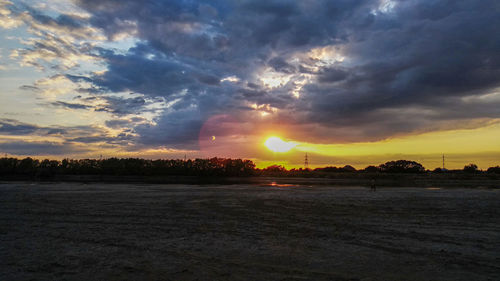 Scenic view of field against sky during sunset