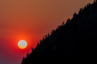 Low angle view of silhouette rocks against sky during sunset