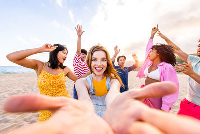 Portrait of friends enjoying at beach