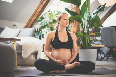 Pregnant woman exercising at home