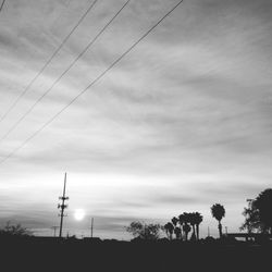 Low angle view of power lines against sky