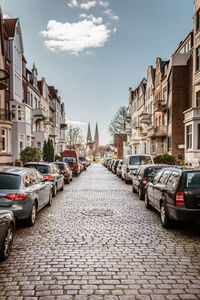 Cars on street amidst buildings in city