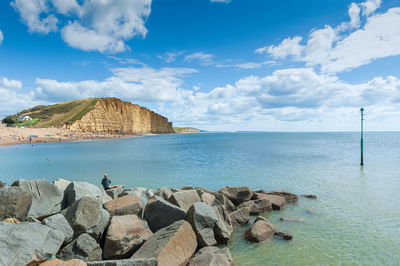 Scenic view of rocks in sea against sky