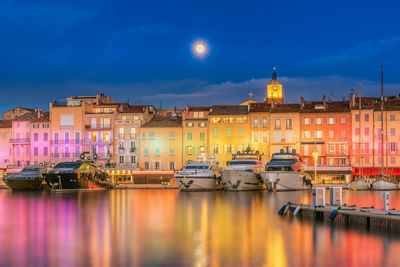 Scenic view of christmas colorful illuminated saint-tropez against full moon