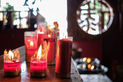 Close-up of illuminated candles on table