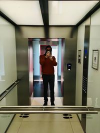 Full length of man standing on escalator