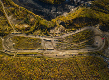 High angle view of road amidst trees on landscape