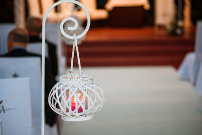 Close-up of electric lamp hanging on table