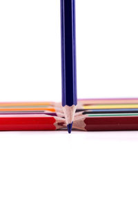 Close-up of colored pencils against white background